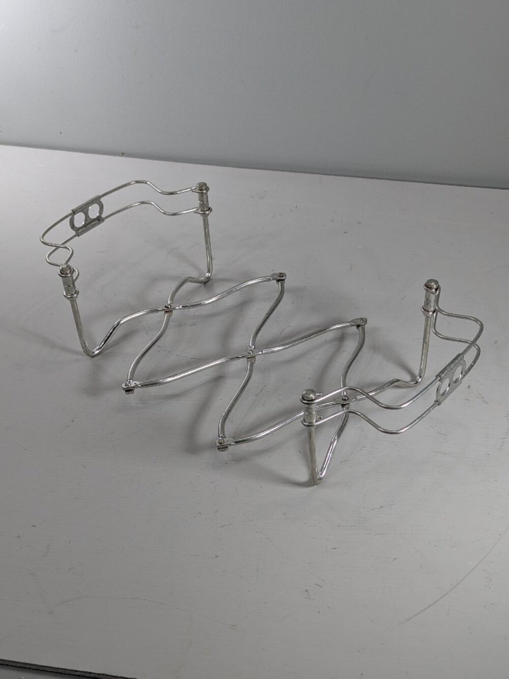 Italian expandable adjustable size metal trivet or casserole dish holder